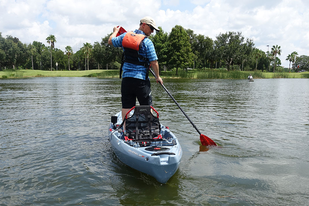 man stands and paddles the Crescent Kayaks Shoalie at ICAST 2022