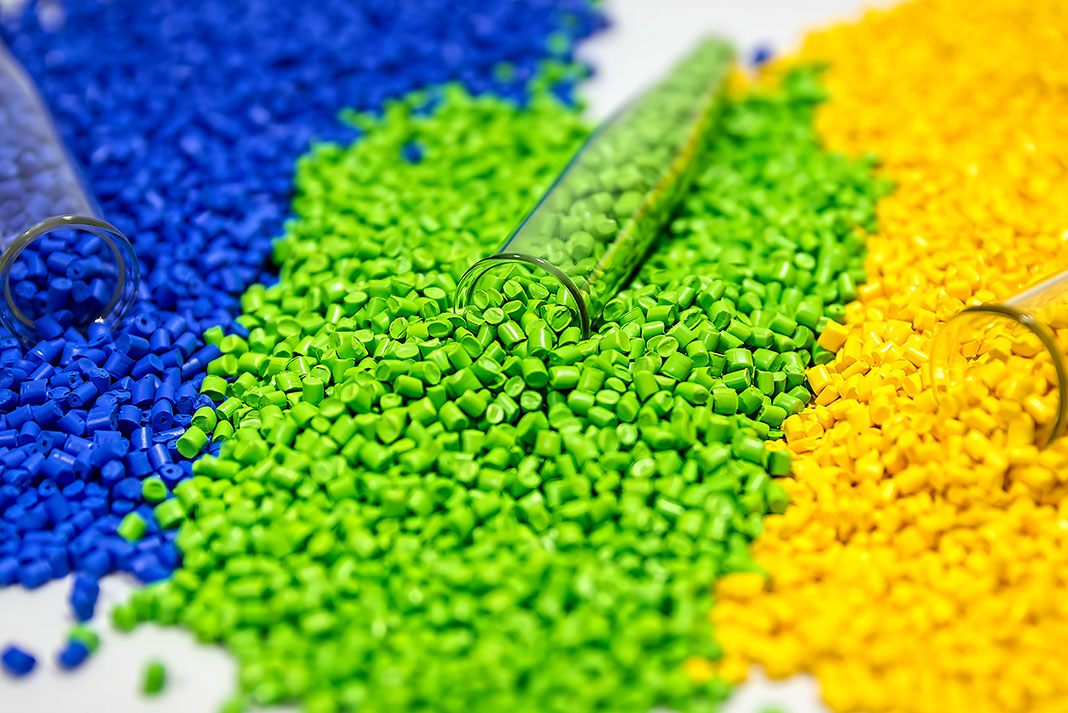 blue, green and yellow plastic pellets used in rotomolded kayak construction