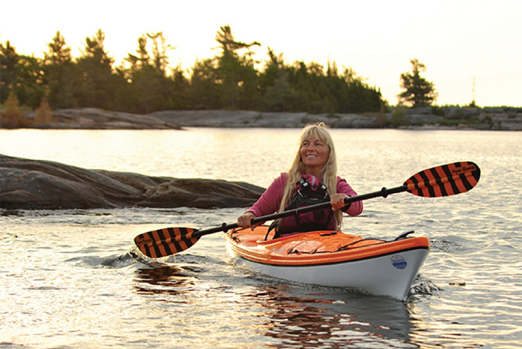 woman paddling a thermoformed kayak