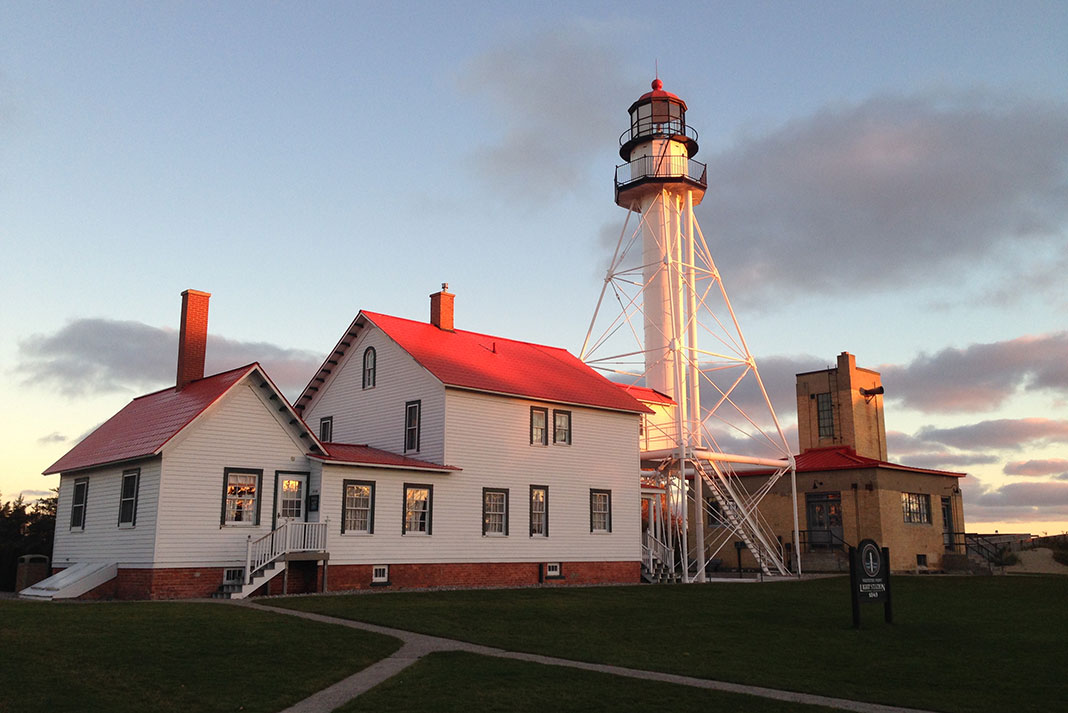 White and red building with lighthouse tower.