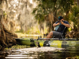 man fishes from a sit-on-top kayak with an all-around bass rod