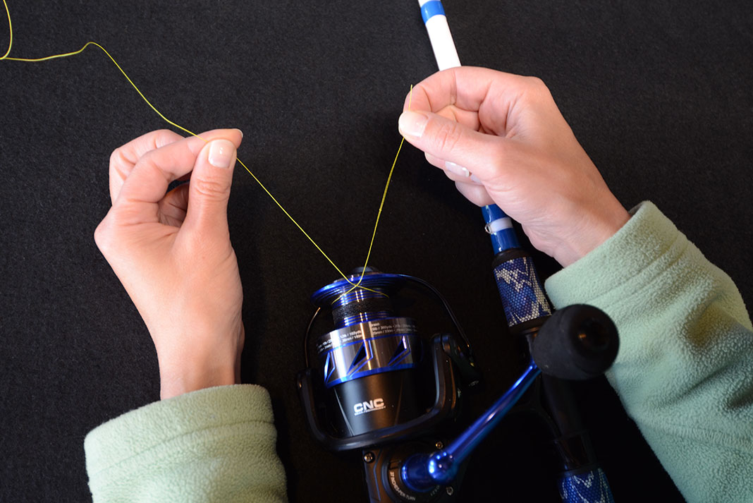 man demonstrates how to spool a fishing reel with the right line