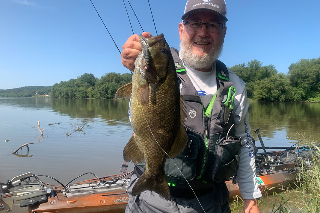 Juan Veruete holds up a bass caught in Pennsylvania