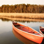 Best Coleman Canoes For 2026 Two red plastic canoes