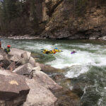 3 Pieces Of Rescue Gear Worth Spending Extra On a whitewater rescuer leaps into the river to save a kayaker using rescue gear