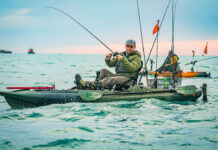 man reels in fish from Old Town Sportsman BigWater PDL 132