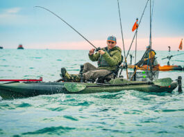 man reels in fish from Old Town Sportsman BigWater PDL 132