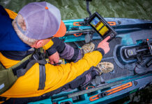 overhead photo of a kayak angler using a fihs finder on his kayak