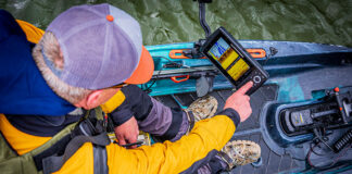 overhead photo of a kayak angler using a fihs finder on his kayak