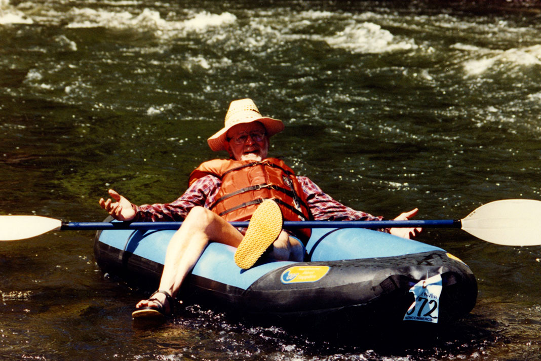 Bill Parks relaxes and spreads his hands on board an inflatable boat