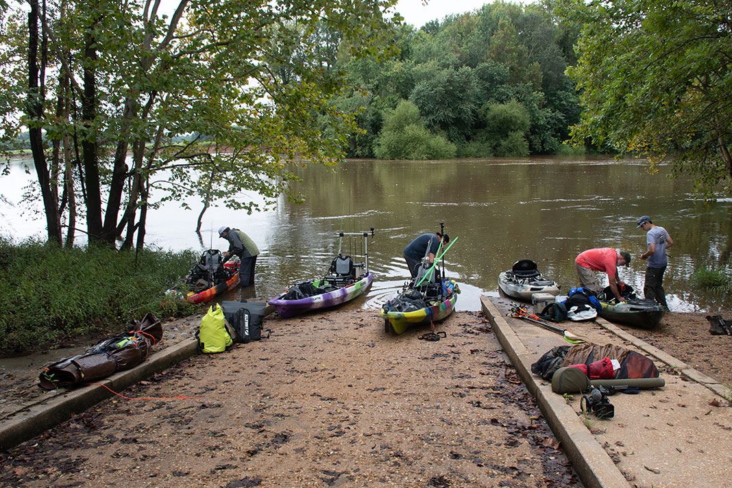 a group of anglers and fishing kayaks at a Tallapoosa River launch