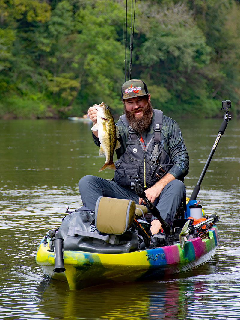 kayak angler holds up an Alabama spotted bass caught on the Tallapoosa River