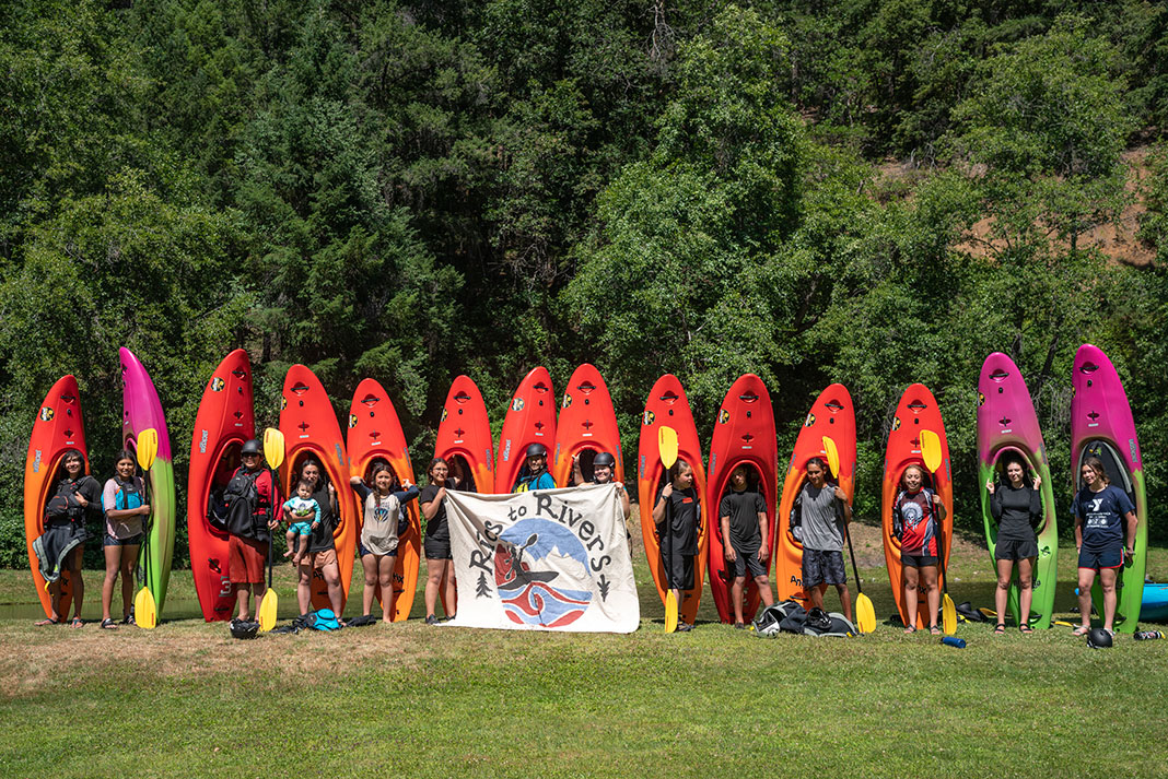 Paddle Tribal Waters youth paddlers pose with their kayaks