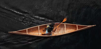 Youth in bark canoe on the Penobscot River