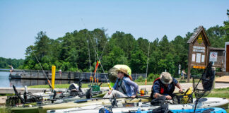 man and woman learn skills at a kayak fishing course