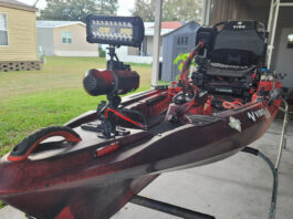 Red fishing kayak with light mounted to front