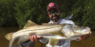 kayak angler holds up large fish in Southeast US