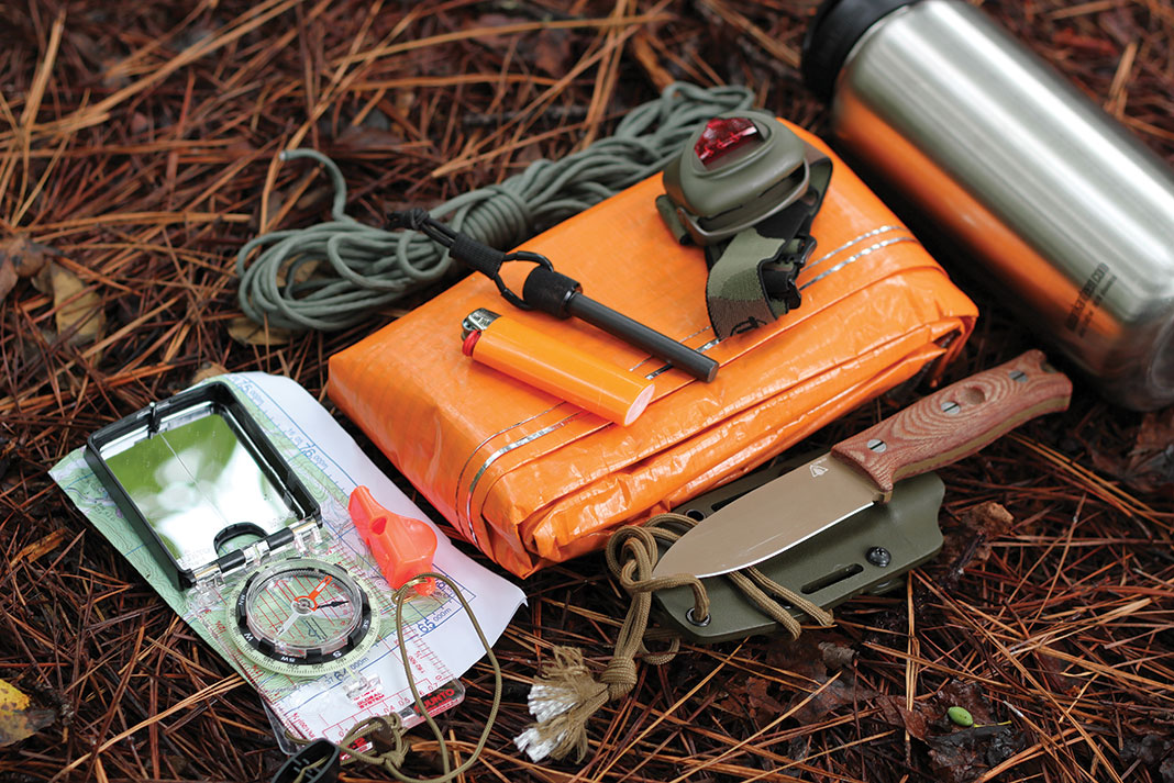 a collection of survival tools making up a backcountry kayak survival kit