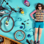 8 Steps To The Ultimate Canoe Bike Trailer Rig Woman surrounded by things needed for a bike canoe trailer rig