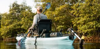 man paddles NuCanoe Unlimited fishing kayak