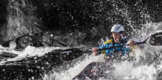 a young man paddles through whitewater on the Gatineau River