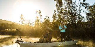 man and woman fish at dawn in the Hobie Mirage Pro Angler 17T tandem kayak