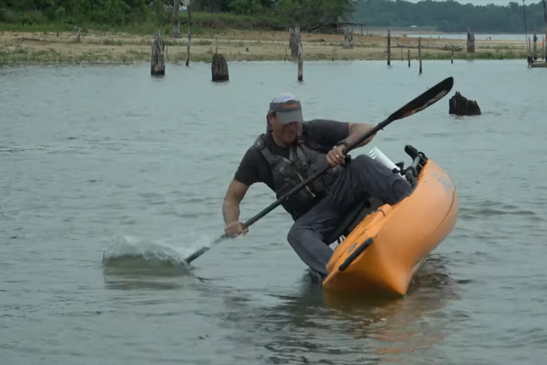 A fishing kayak about to flip