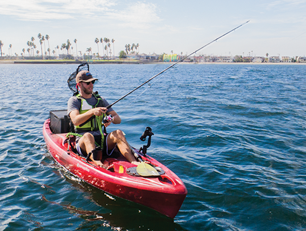 Man fishing from red sit-on-top kayak