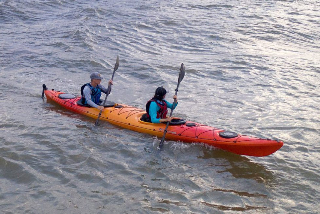 Two people in a tandem sit-in kayak