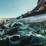 Fishing Kayak Review: Ascend 10t Grey sit-on-top fishing kayak being paddled on wavy waters