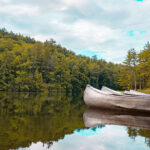 Best Aluminum Canoes For 2026 aluminum canoes sit on a calm lake