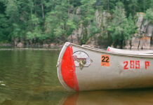 Grumman canoe sits on lake