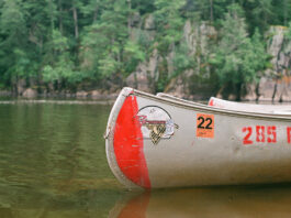 Grumman canoe sits on lake