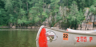Grumman canoe sits on lake