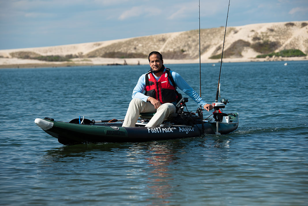 man motors on a Sea Eagle inflatable fishing kayak
