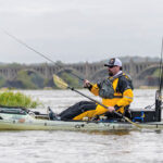 Angler fishing in a drysuit in his kayak