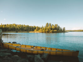 Wenonah canoe sitting on a lakeshore