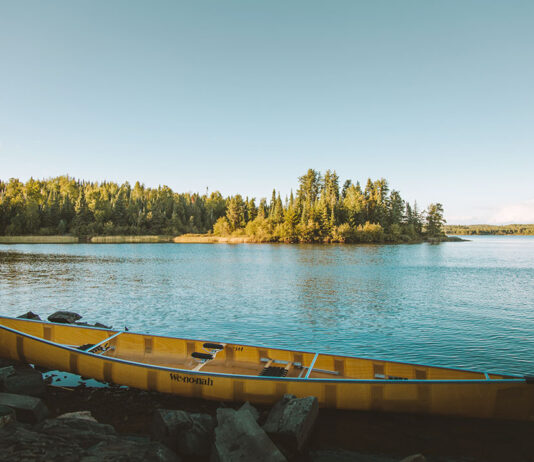 Wenonah canoe sitting on a lakeshore