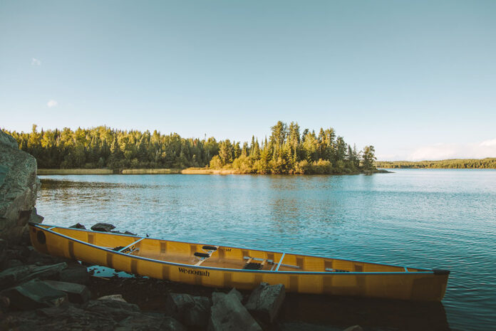 Wenonah canoe sitting on a lakeshore