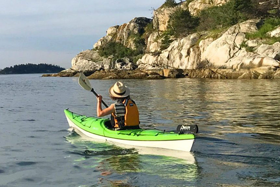 Man paddling in sit-in kayak