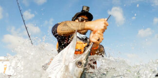 man grabs a sailfish in Flotsam, an offshore kayak fishing film