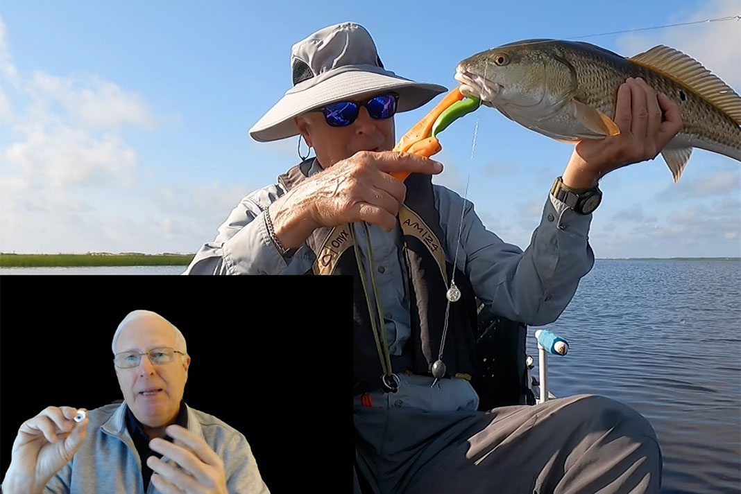 man holds up redfish caught with an LED fishing light
