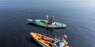 man and woman paddle in Pelican Bandit NXT kayaks