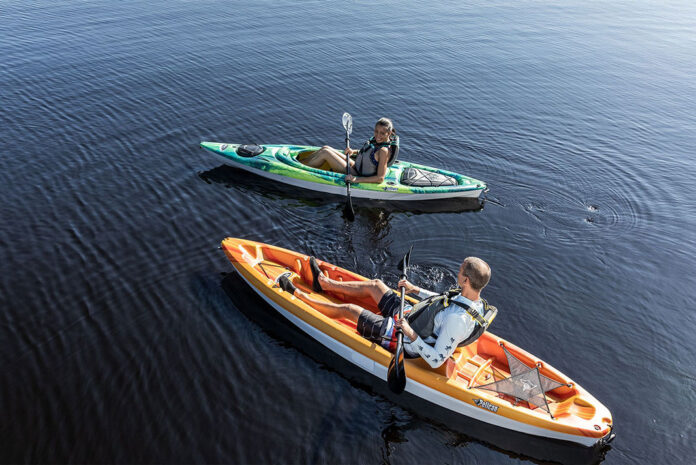 man and woman paddle in Pelican Bandit NXT kayaks