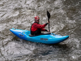 man paddles the Pyranha Scorch whitewater kayak