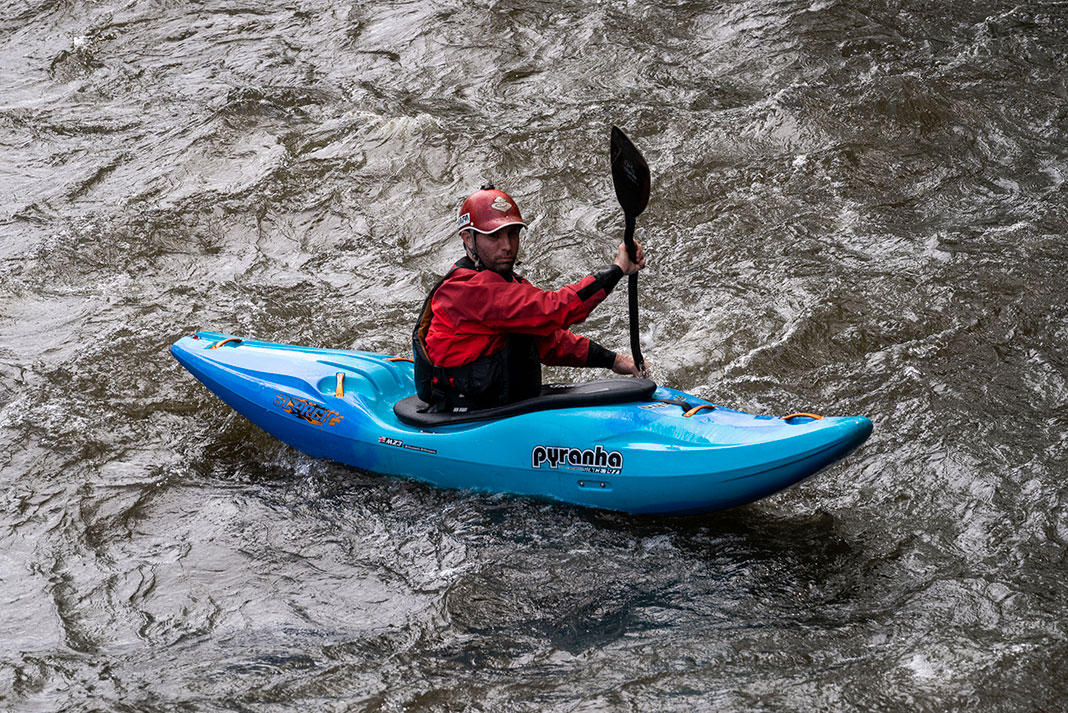 man paddles the Pyranha Scorch whitewater kayak