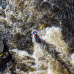 The Essential Rescue Skill Outdoor Programs Stopped Teaching overhead shot of a group of whitewater paddlers performing a complex rescue aided by a thorough knowledge of knots