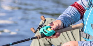 person holds a fishing rod with saltwater reel from 13 Fishing