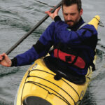 Learn The Sea Kayak Bow Draw man demonstrates the bow draw in his sea kayak