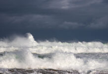 ocean waves crash in high wind